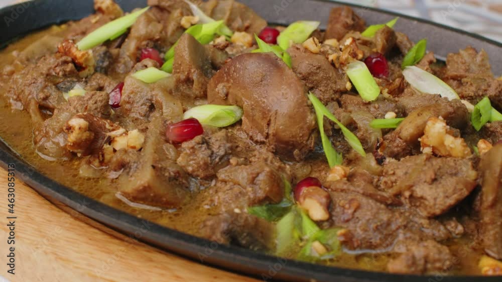 Beef stew in frying pan on table, close up view