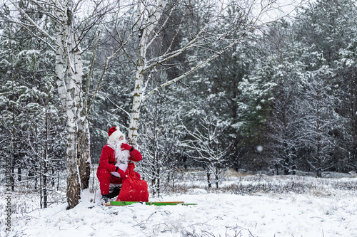 Santa Claus squatted to rest in the woods