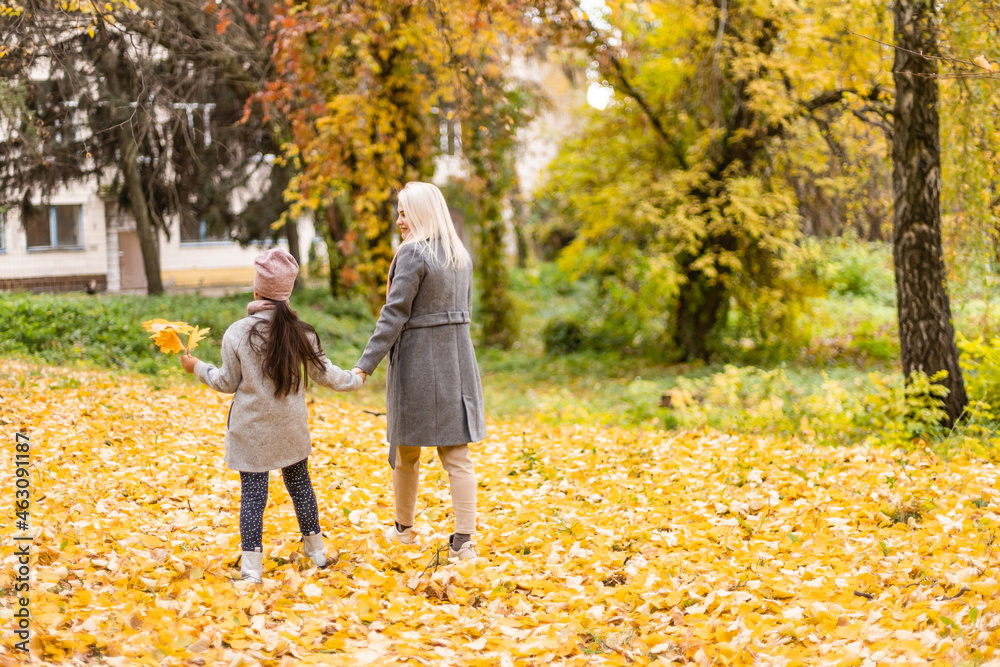 Mother and daughter in autumn yellow park Mother and daughter in autumn yellow park