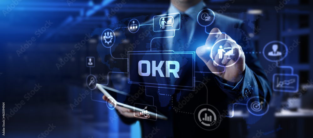 OKR Objectives key results. Businessman pressing button on screen. OKR Objectives key results. Businessman pressing button on screen.