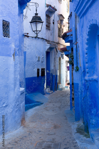 Chefchaouen, Morocco - 6 October, 2021: Blue street and houses in Chefchaouen, Morocco. Beautiful colored medieval street painted in soft blue color. © romeof