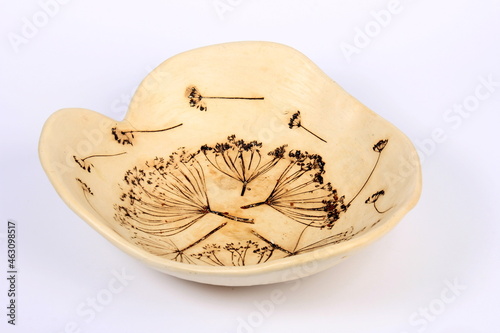 white clay pot with plant imprint on a white background, handmade clay pot 