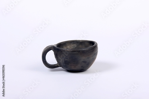 black clay mug on a white background, handmade clay bowl, clay coffee mug 