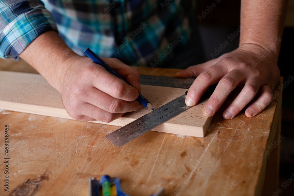 Joinery. Close-up workers. The carpenter measures with a ruler and draws with a pencil. Tree. Ecological compatibility. Lifestyle. Joinery. Close-up workers. The carpenter measures with a ruler and draws with a pencil. Tree. Ecological compatibility. Lifestyle.