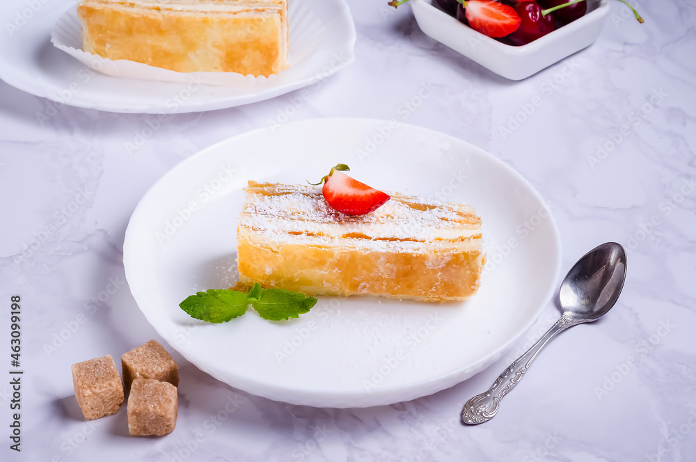 Puff pastry cake with cream on a plate Puff pastry cake with cream on a plate