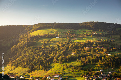 Sunrise over landscape with small town in hills of La Bresse, Vosges, France