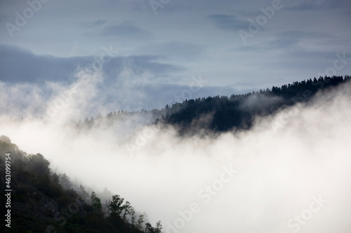 Clouds and fog over mountains and hills during sunrise in the Vosges, France
