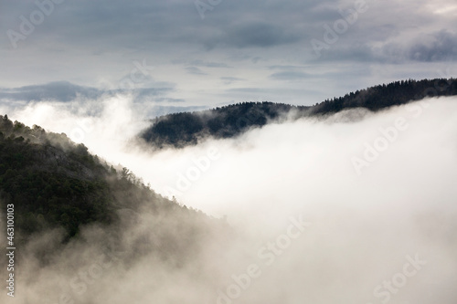 Clouds and fog over mountains and hills during sunrise in the Vosges, France