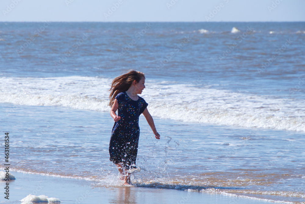 child running on the beach, girl playing on the beach, british beach, british, summer, british summer, norfolk beach, cromer, child, playing, beach