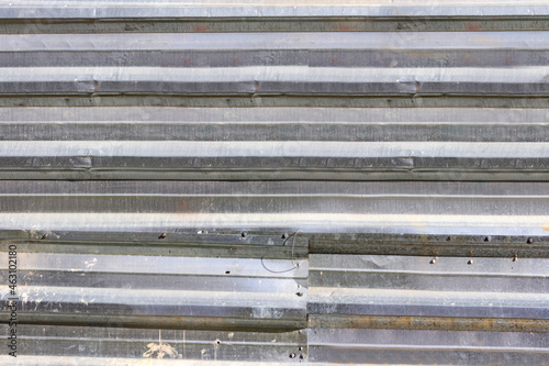 Photo texture of old and worn metal fence shields.