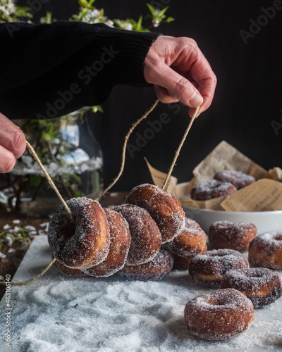 Crop woman with fritters on thread photo