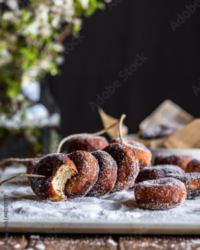 Fritters in sugar powder on table photo