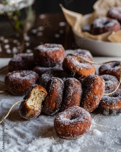 Fritters in sugar powder on table photo