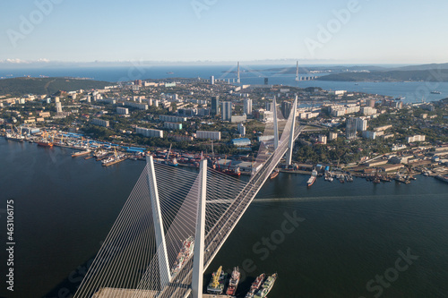 Aerial view of Vladivostok city center above buildings, bridges, embankment and ships