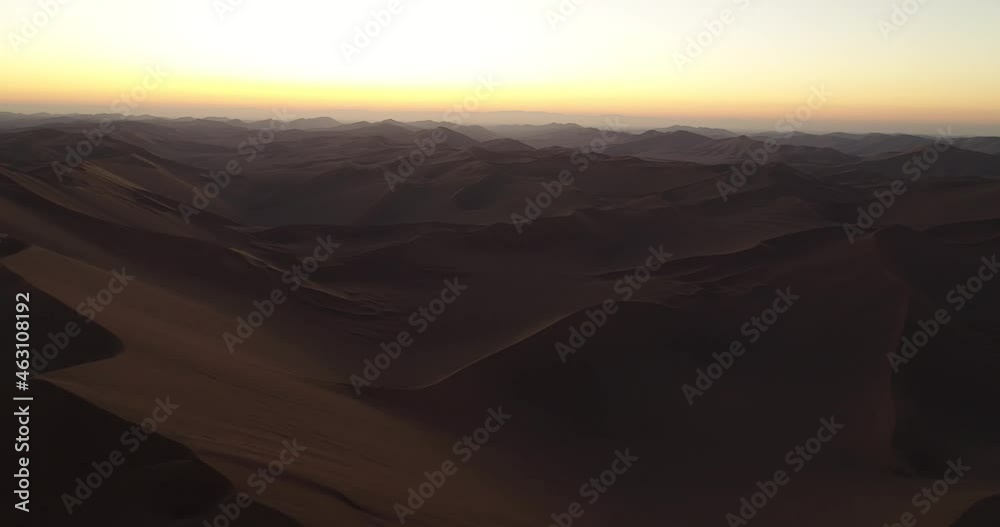 aerial pan left shot from the shape of sand dunes in the Lut desert, aerial high attitude sunset shot from sand dunes. aerial pan left shot from the shape of sand dunes in the Lut desert, aerial high attitude sunset shot from sand dunes.