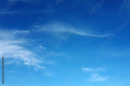 Blue sky with sparse white clouds, can be used as background