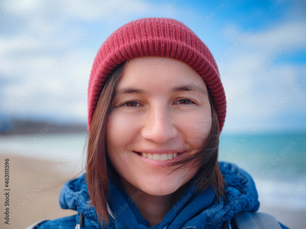 woman taking selfie on smartphone, female travels along the coast in the cold season. Outdoor. POV. Close up