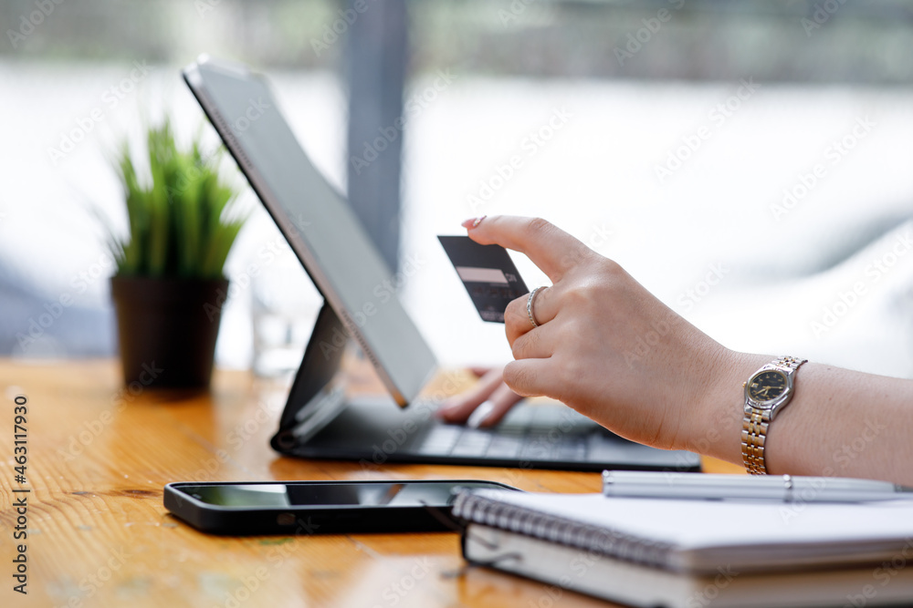 Young Asian women hand using a credit card and tablet computer payments for online shopping, Online shopping, digital banking, E-commerce concept. Young Asian women hand using a credit card and tablet computer payments for online shopping, Online shopping, digital banking, E-commerce concept.