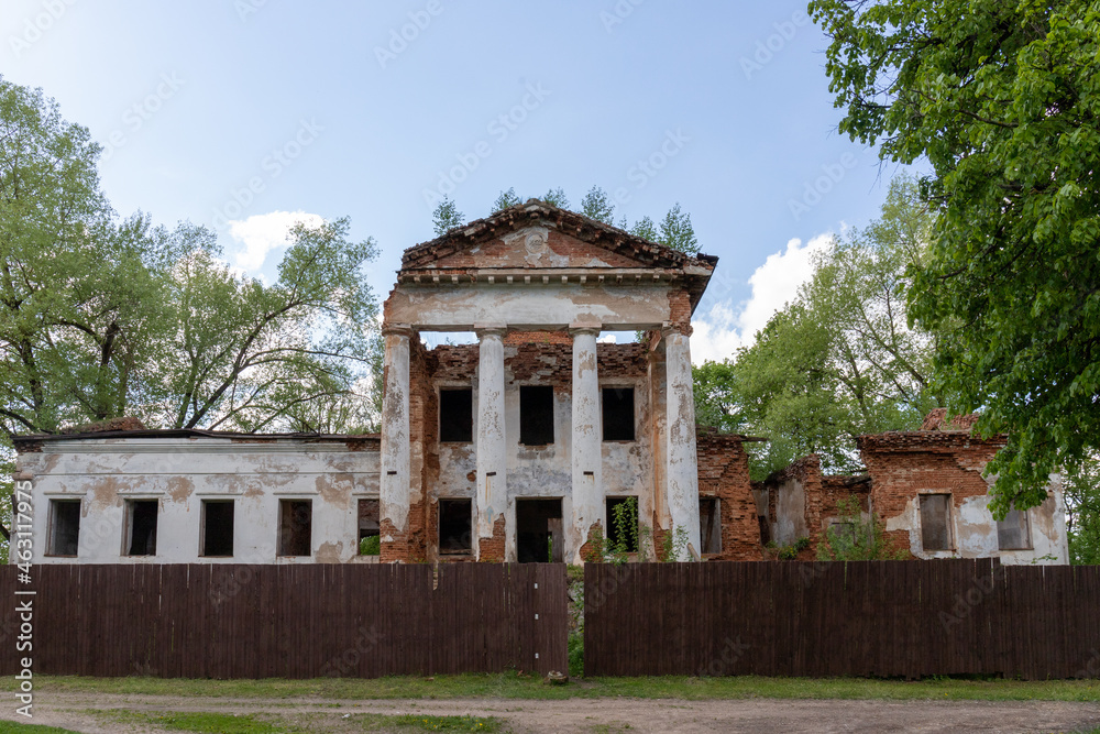 a century-old decaying palace surrounded by a fence for reconstruction