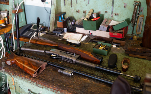 Принти на полотні Disassembled automatic rifle on the table of the weapons workshop