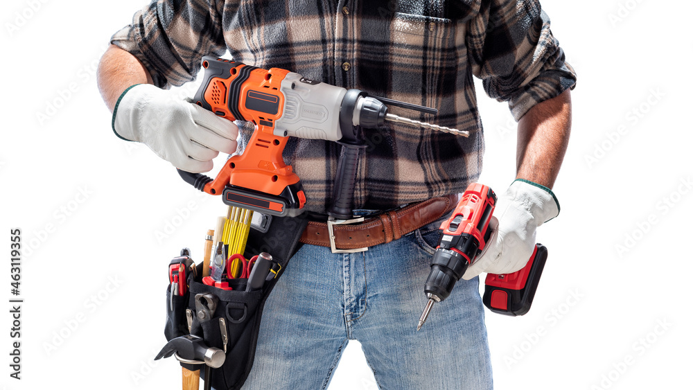 Carpenter holding rechargeable hammer drill and the rechargeable screwdriver, isolated on white background. Work safety. Carpenter holding rechargeable hammer drill and the rechargeable screwdriver, isolated on white background. Work safety.