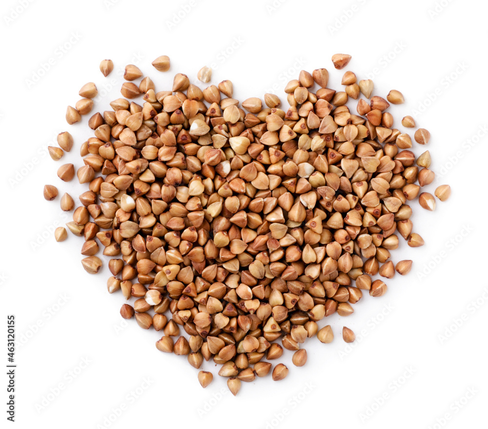 Buckwheat groats in the shape of a heart on a white background, isolated. Top view Buckwheat groats in the shape of a heart on a white background, isolated. Top view