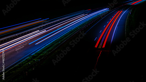 Night road lights. Lights of moving cars at night. long exposure red, blue, green, orange.