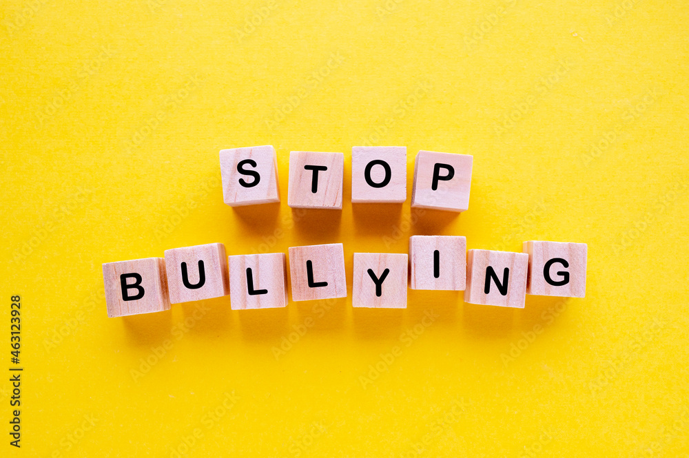 Obraz premium Stop Bullying wooden blocks with letters on yellow background
