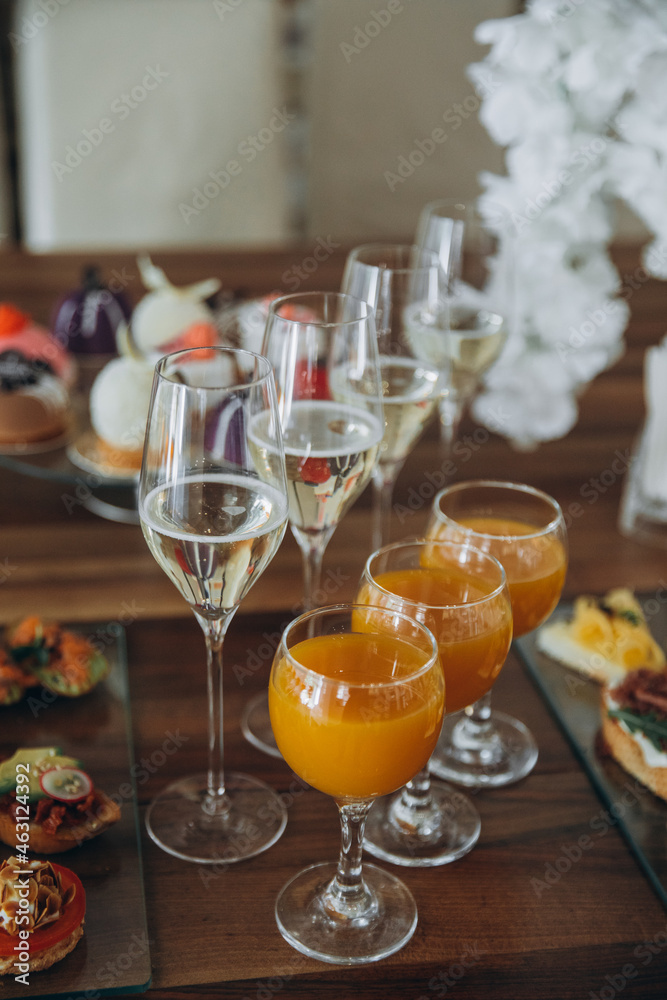 festive table, on the table are glasses with water and juice. there is food on the table