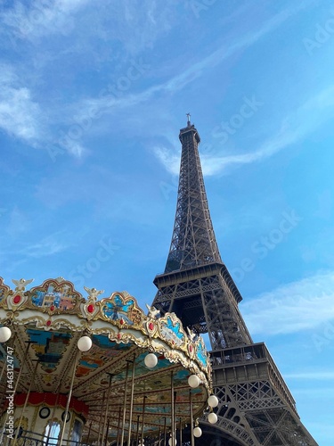 carousel with Eiffel tower in Paris against the blue sky on a sunny day