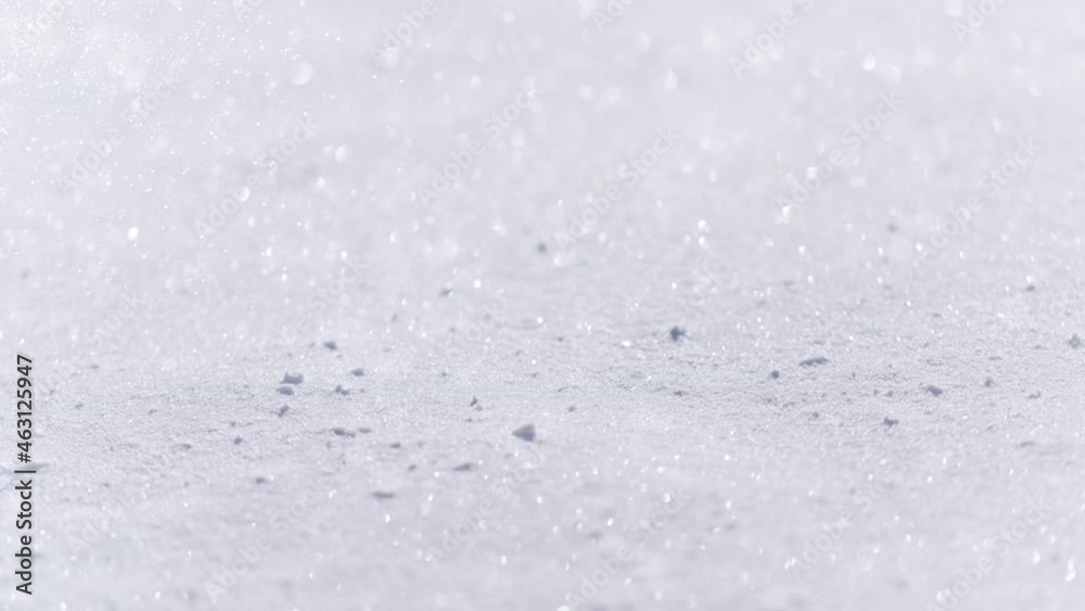 Blurred snow texture with shining snowflakes copy space white background.