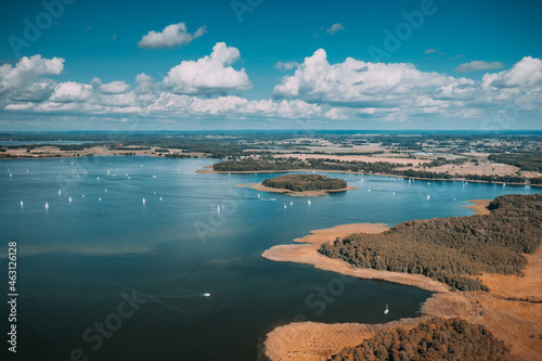 Aerial view of green islands and clouds at summer sunny day. Masurian Lake District in Poland. 