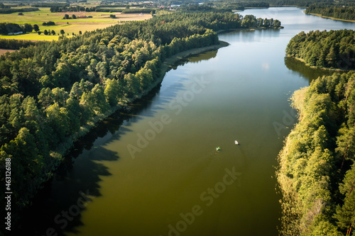 Aerial view of green islands and clouds at summer sunny day. Masurian Lake District in Poland. 