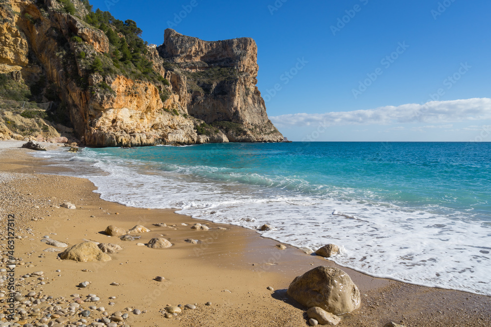 Mediterranean beach clear blue water cliffs and fine sand in Spain beautiful travel background

