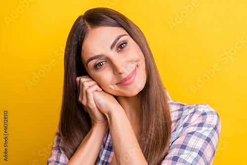 Photo of young attractive woman happy positive smile hands touch cheek dream isolated over yellow color background © deagreez