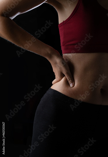 A woman is having muscle pain after exercise.
