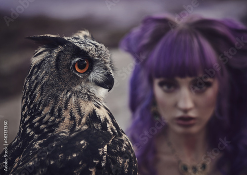 beautiful woman with owl in the nature photo