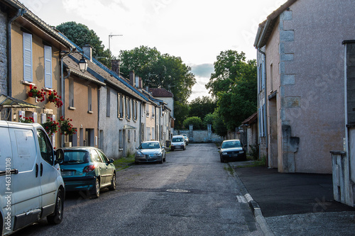 Fototapeta Naklejka Na Ścianę i Meble -  streets with parked cars in the small village of Arc en Barrois in the French Champagne Ardenne in the evening