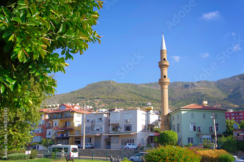 Turkey. Alanya. 15.09.2021. View of city houses and a mosque against the backdrop of mountains. photo