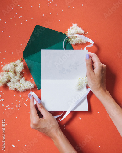green envelope in hands on an orange background