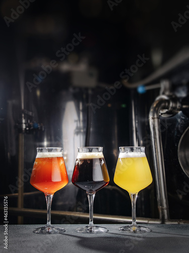 Three beer glasses at the dark background.