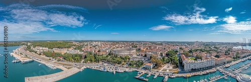 Drone panorama of the Croatian coastal city of Pula taken during the day above the harbor