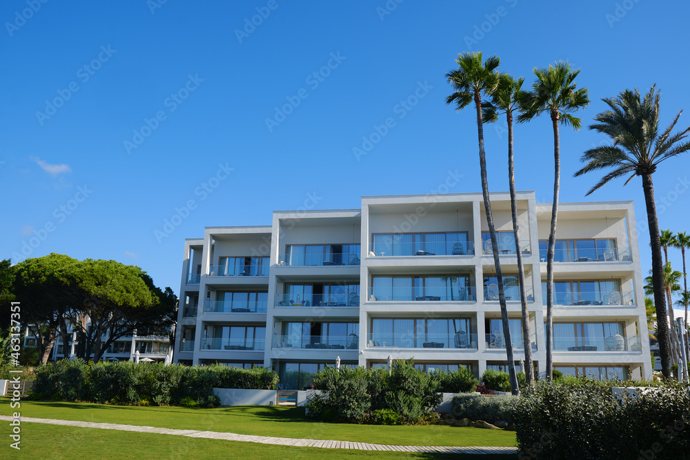 Modern luxury residential flat, concept home. Modern apartment building on a sunny day with a blue sky.