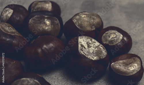 Chestnuts on gray table for natural banner concept