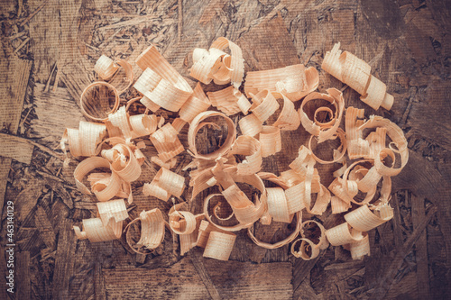 Wood shaving on table background. Wooden shavings at old plank board texture