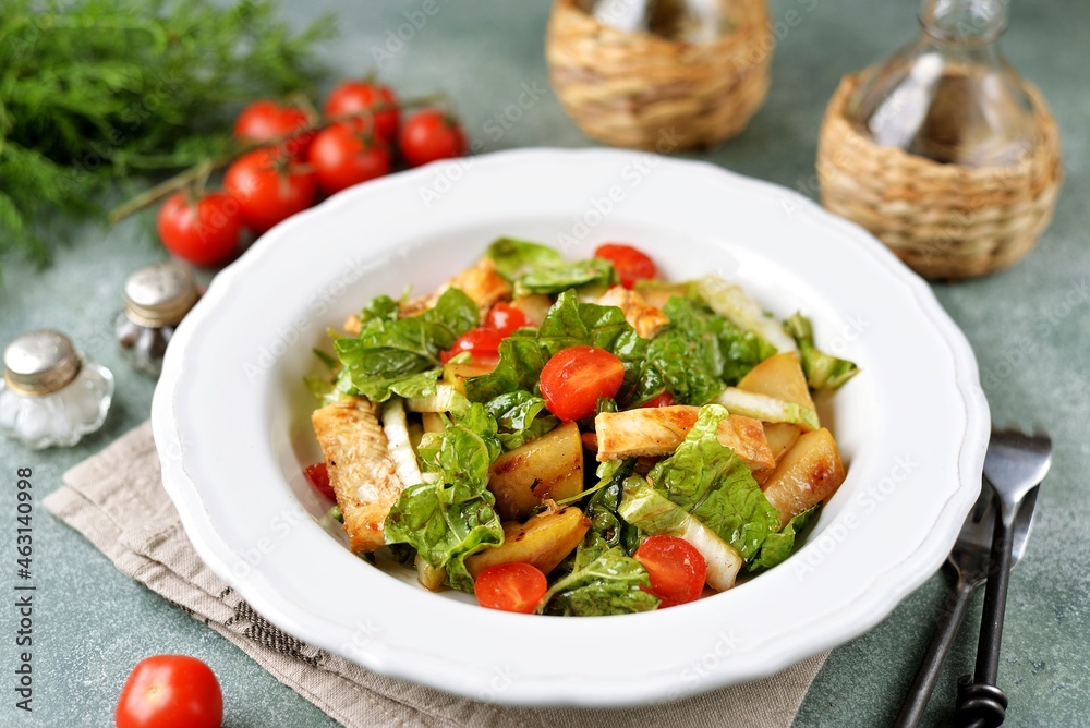 Grilled chicken breast salad with lettuce, Chinese cabbage, cherry tomatoes, olive oil and wine vinegar.