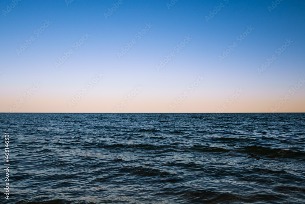 Dawn over the horizon of the dark ocean waters Dawn over the horizon of the dark ocean waters