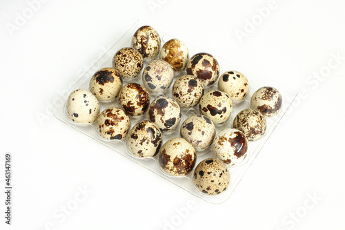Bunch of small quail eggs isolated on white background