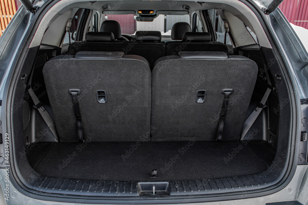 Huge, clean and empty car trunk in interior of compact suv. Rear view of a SUV car with open trunk Huge, clean and empty car trunk in interior of compact suv. Rear view of a SUV car with open trunk