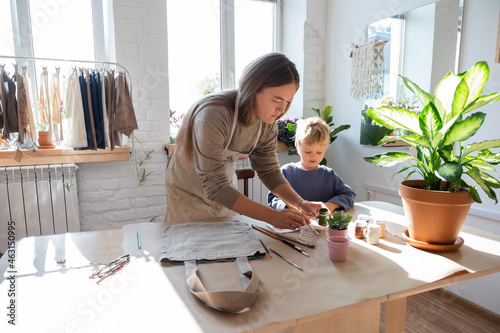 Mother and son crafting cotton bags photo